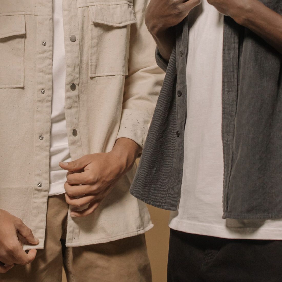 Stylish men's casual fashion featuring layered outfits with beige and gray tones.